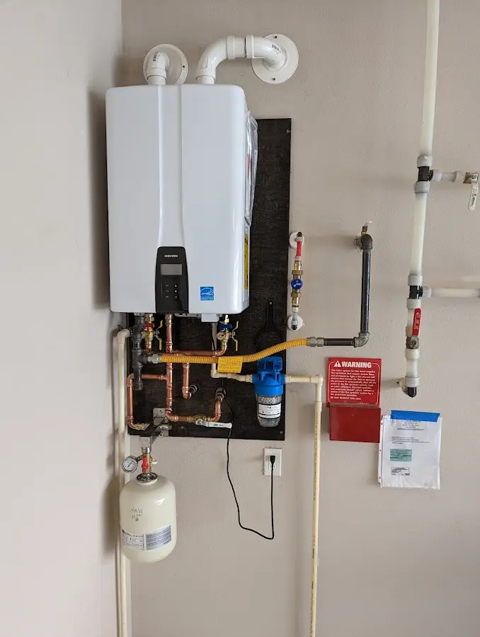 Professional plumber installing copper piping in a Pittsfield home